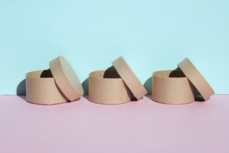 Round craft cardboard boxes for product on blue pink pastel background