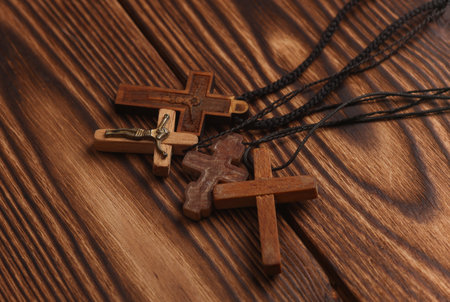 Wooden Christian crosses on a string, wooden background.の写真素材