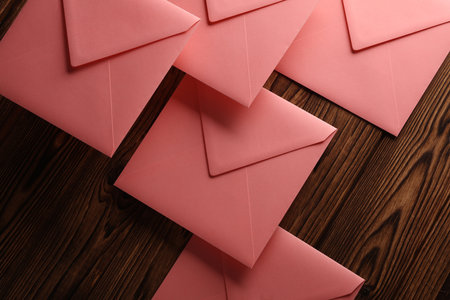 Pink square paper envelopes on wooden backgroundの写真素材