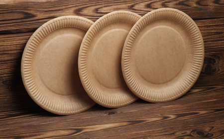 Cardboard eco plates on wooden backgroundの写真素材