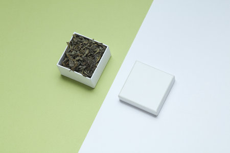 Green tea in white cardboard box on pastel backgroundの写真素材