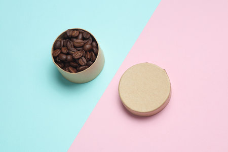 Coffee beans in box on pink blue background. Top viewの写真素材