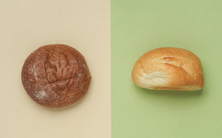 Wheat and rye buns on pastel background