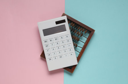 Abacus and calculator on a blue-pink background. Business conceptの写真素材