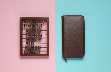 Abacus and purse on a blue-pink background. Business concept
