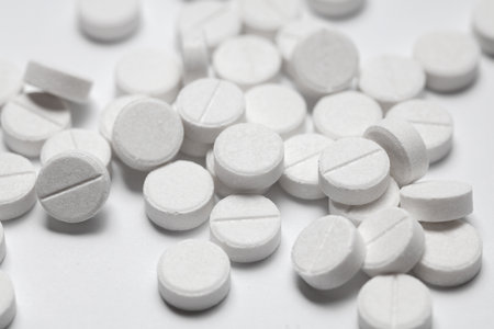 Close-up of white pills on a white background. Medicine concept