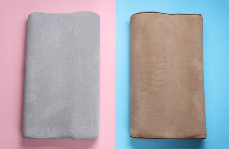 Orthopedic two pillows on a blue-pink pastel background. Healthy and comfortable sleepの写真素材