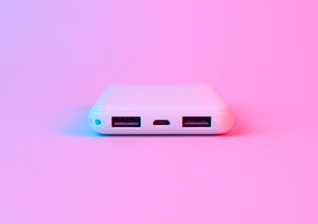 Modern power bank in blue-pink gradient neon lightの写真素材