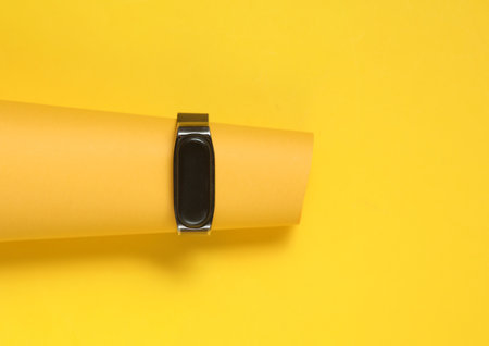 Smart watch on yellow background. Modern gadget. Minimalism. Creative layoutの写真素材