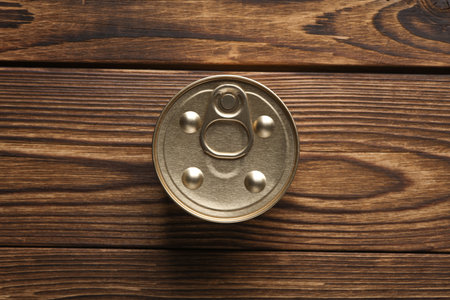 Can with canned pet food on wooden background. Top view. Flat lay