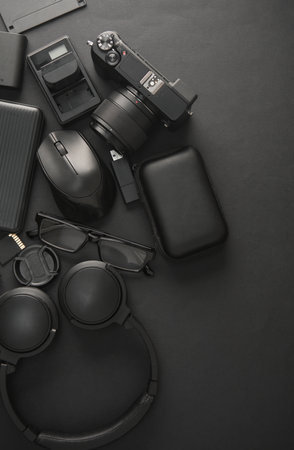 Flat lay composition of Modern black gadgets and accessories on dark black background. Top view.の写真素材