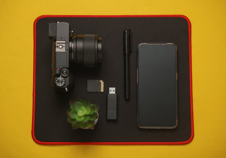 Equipment of modern photographer on a yellow background. Top view. Flat layの写真素材