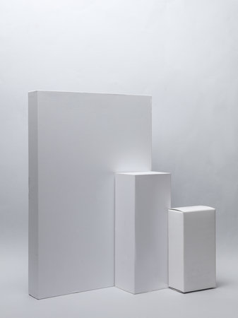 Different shapes of white cardboard boxes for presentation products on white background. Mockup for...