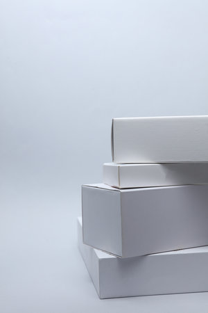 Different shapes of white cardboard boxes for presentation products on white background. Mockup for design.の写真素材