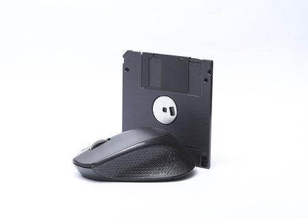 PC mouse with floppy disk on white background
