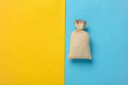 Mini burlap pouch on a blue yellow background