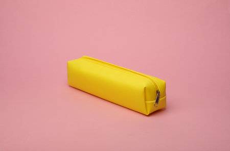 Yellow school pencil case on a pink background