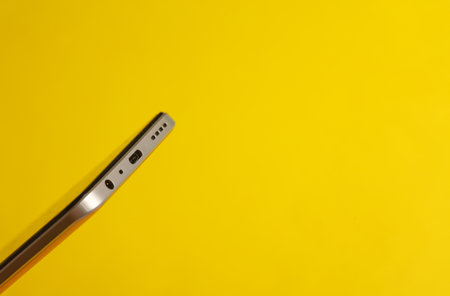 Smartphone inputs on yellow background close up
