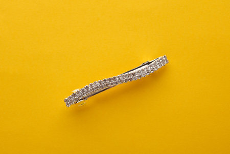 Jewelry hairpin on a yellow background. Top viewの写真素材