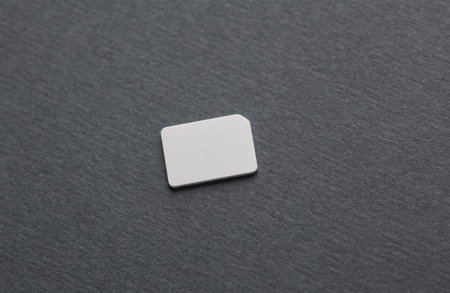 White blank sim card mockup on dark gray background