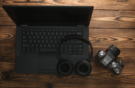 Laptop with camera and headphones on wooden background. To pview. Flat layの写真素材
