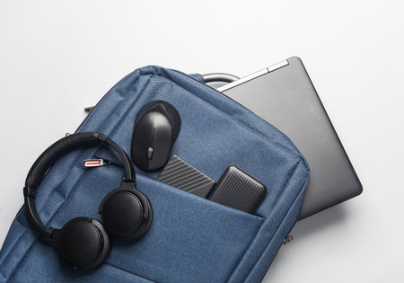 Modern gadgets For work and study. Backpack with laptop, headphones, external hard drive, pc mouse...