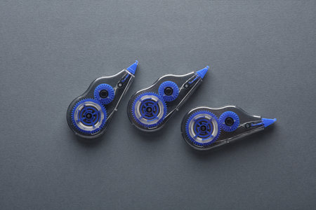 Tape correctors on dark gray background. Top view