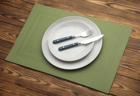 Set of dishes and cutlery for table setting on wooden background