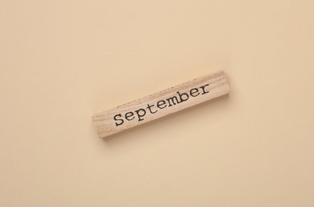 Wooden board with month september on beige backgroundの写真素材