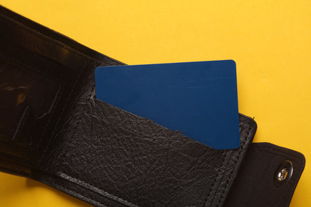 Leather wallet with credit cards on a yellow backgroundの写真素材