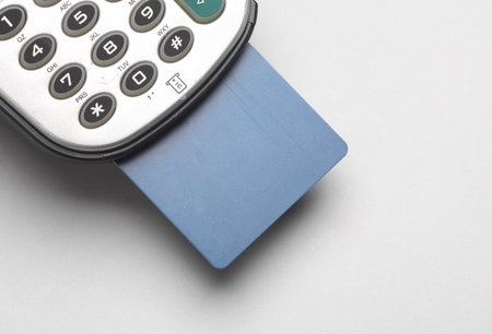 POS terminal with credit card on a gray backgroundの写真素材