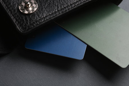 Credit cards in wallet on dark gray background