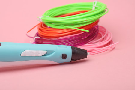 3D pen and PLA plastic on pink background. Children's Creativity.の写真素材