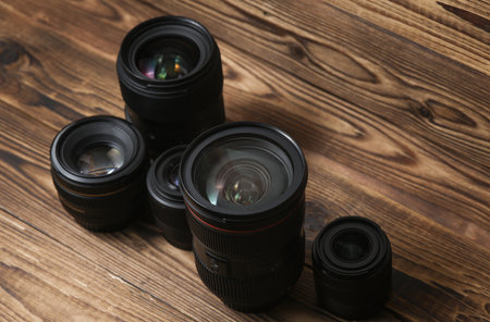 Set of Professional photographic or videographic lenses on a wooden background. Photographer's equipmentの写真素材