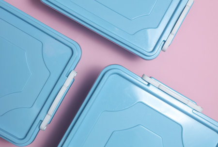 Blue Plastic containers for storing food on a pink background. Top view