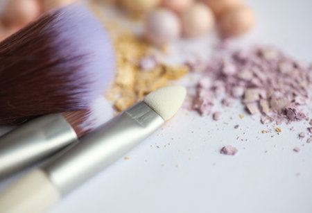 Brushes with Crushed make-up balls of eye shadow on a white background close-up. Beauty conceptの写真素材