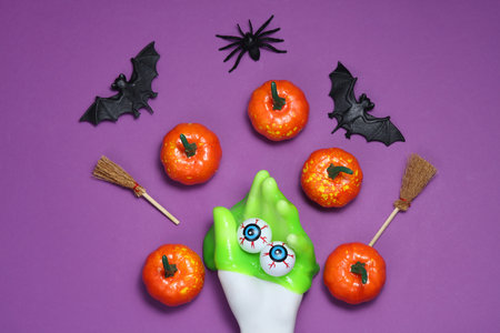 Flat lay composition of Halloween decor on a purple backgroundの写真素材