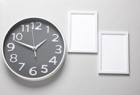 Wall clock, photo frame on gray backgroundの写真素材