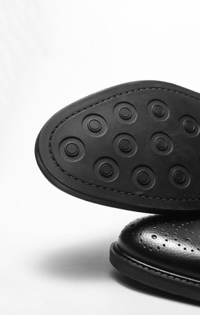 Close up of brogue boot sole on white background
