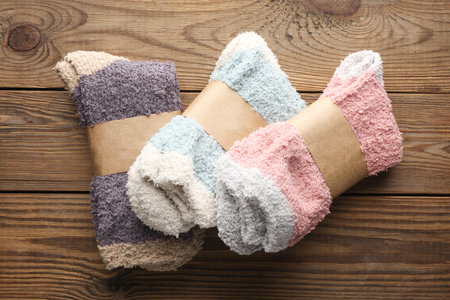 New socks with wrapped tags on wooden background
