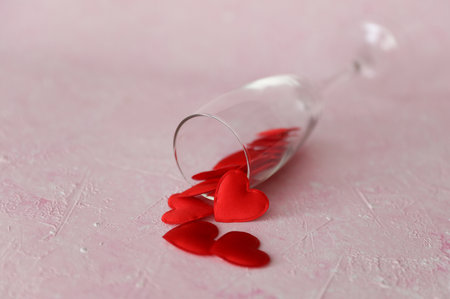 glass with red hearts on a pink concrete backgroundの写真素材