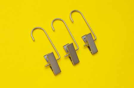 Hangers for pants or trousers on yellow background