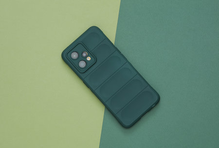 Smartphone in protective case on a green backgroundの写真素材