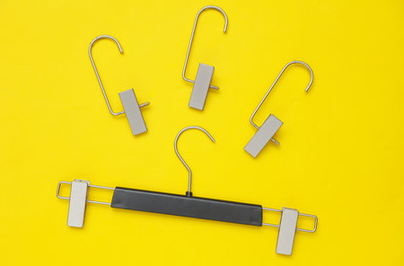 Hangers for pants or trousers on yellow background