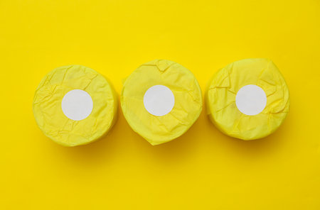 Paper product packaging with white sticker on yellow backgroundの写真素材