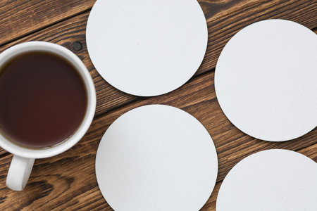White round empty coasters Mockup and coffee cup on wooden background