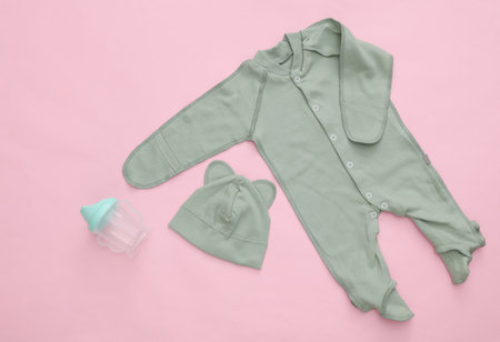 Newborn baby clothes on a pink background. Top view. Flat layの写真素材