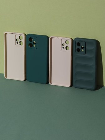 Protective cases for smartphones on green backgroundの写真素材