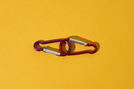 Climbing carabiners on a yellow backgroundの写真素材
