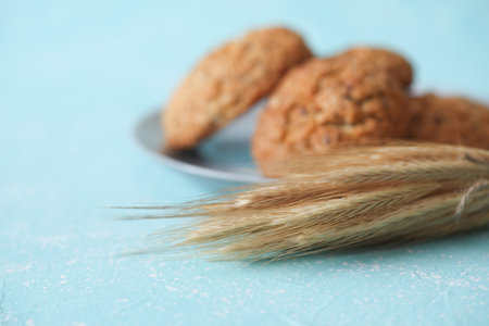 Cereal cookies with ears of wheat on blue concrete backgroundの写真素材